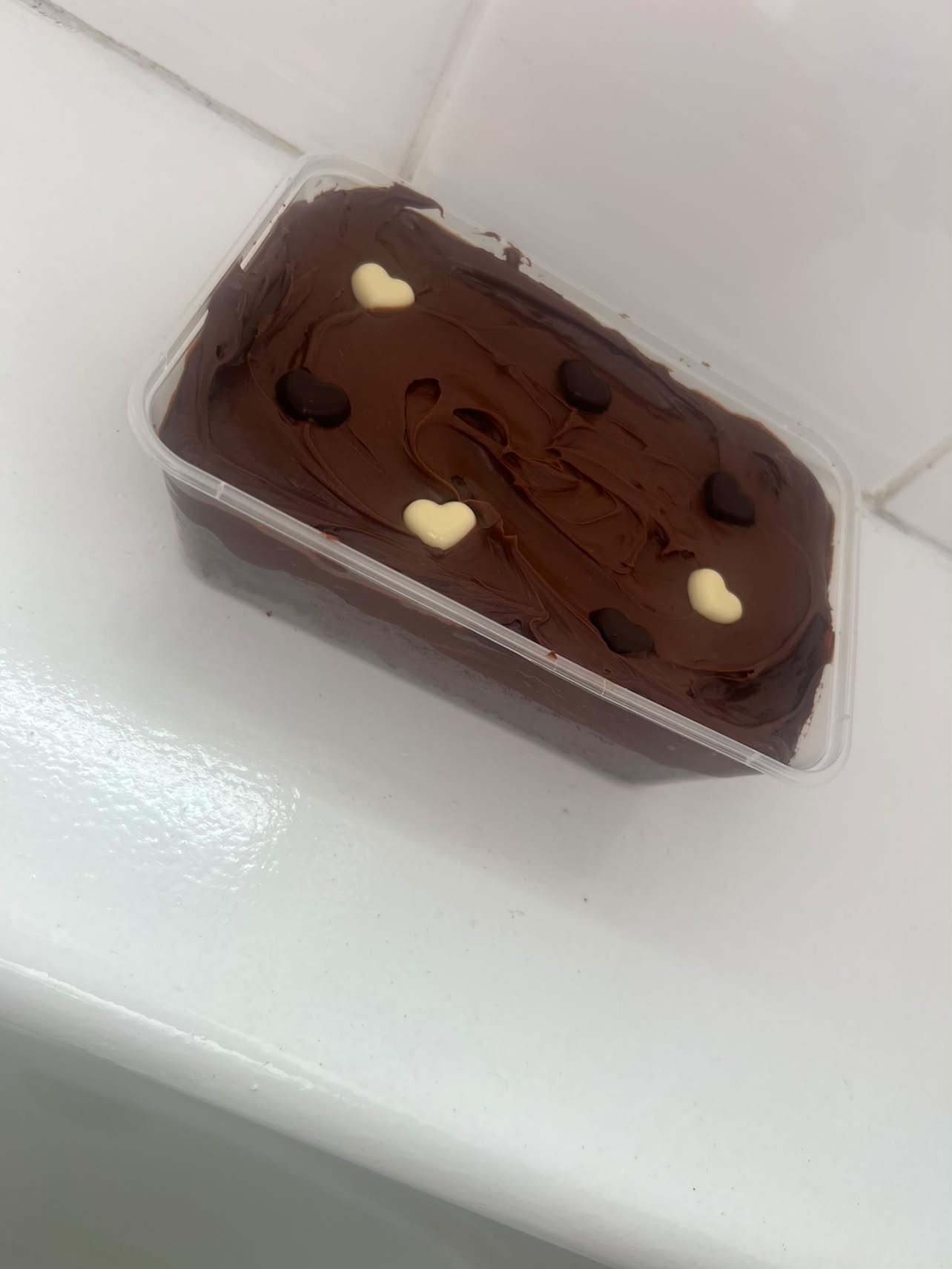 Chocolate cake tub by Bella & Bloom Co. topped with rich chocolate icing and chocolate hearts